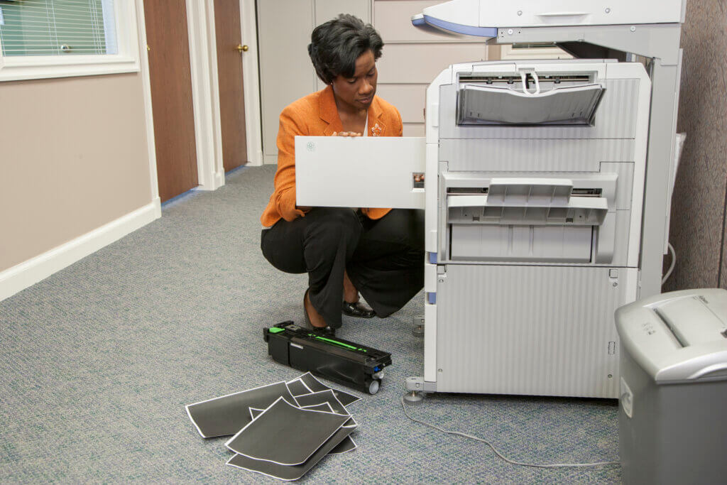 Women using a white copy machine